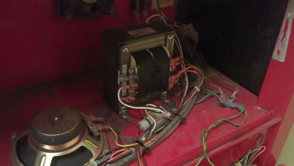 Internal components of an electronic device with transformer, speaker, and wiring.