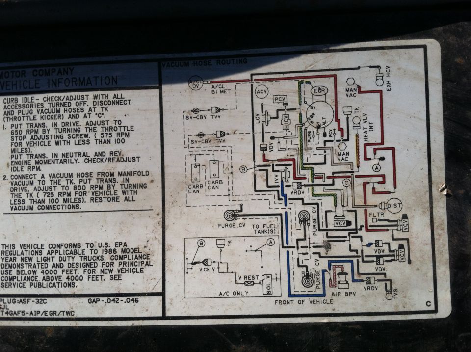 Ford vehicle emission information label with vacuum hose routing diagram and idle adjustment steps