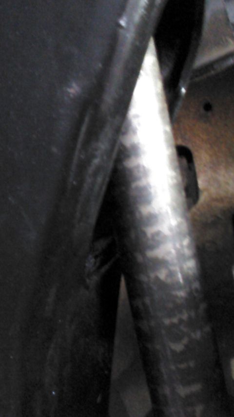 1996 Ford Bronco - This close-up image shows a metallic pipe that appears to be part of a vehicle's exhaust system, possibly from a 1996 Ford Bronco. The pipe…