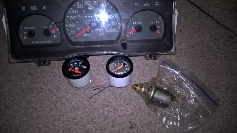 2004 Ford Crown Victoria - A car's instrument cluster is shown with two aftermarket gauges, an oil pressure gauge and a tachometer, laid out in front of it. A pressur…