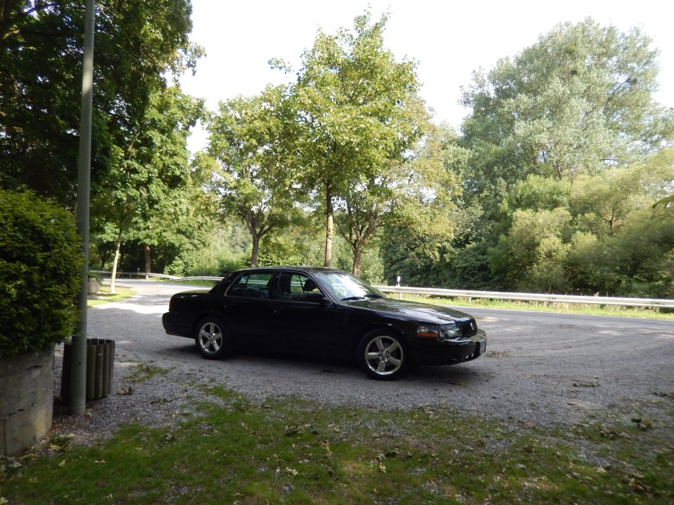 Black 2003 Mercury Marauder parked on gravel.