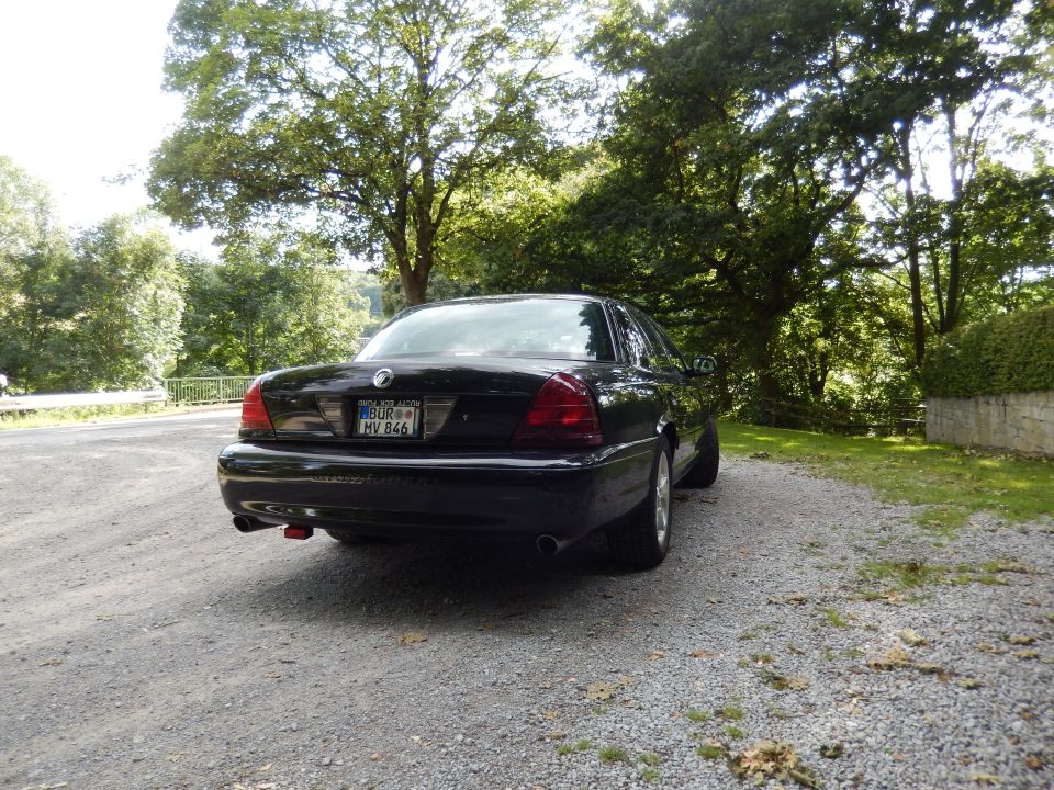 Black 2003 Mercury Marauder rear passenger side view on gravel