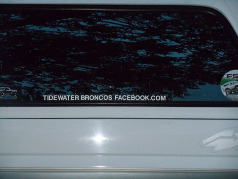 Rear window of a white Ford Bronco with a "TIDEWATER BRONCOS FACEBOOK.COM" sticker.