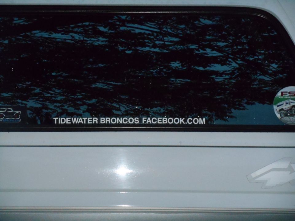 Rear window of a white Ford Bronco with a "TIDEWATER BRONCOS FACEBOOK.COM" sticker.