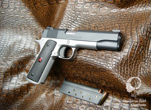 1979 Ford Bronco - A close-up, high-angle shot shows a Colt Government Model semi-automatic pistol with a magazine lying next to it on a textured brown surfac…