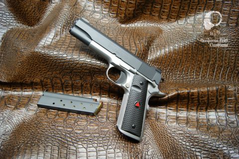 1979 Ford Bronco - A close-up of a handgun and an empty magazine resting on a textured brown surface that resembles alligator skin. A watermark with a logo an…