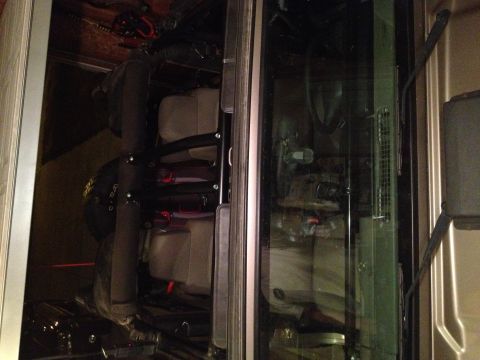 2005 Jeep Wrangler - The interior of a vehicle is shown, with a focus on the seats and storage area. A black helmet with yellow lettering is visible in the fore…