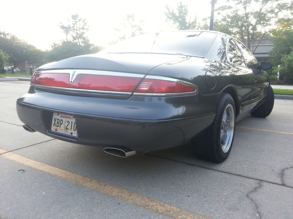 Dark gray 1998 Lincoln Mark VIII rear passenger side view with Louisiana license plate
