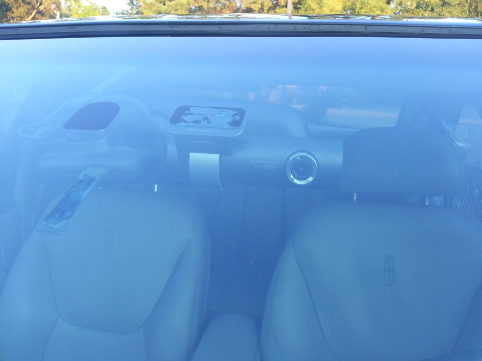 Lincoln car interior front seats and dash viewed through windshield