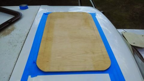 1992 Ford Bronco - A plywood template is taped over a vehicle's sunroof opening, likely for modification or repair.