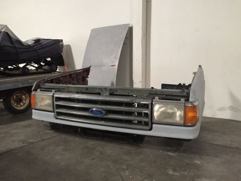 1988 Ford Bronco - Front end assembly, likely for a 1988 Ford Bronco, the grille and headlights.