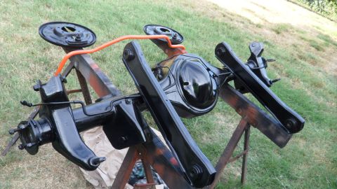 1972 Ford Ranchero - A freshly painted rear axle assembly sits on sawhorses outdoors, ready for installation.