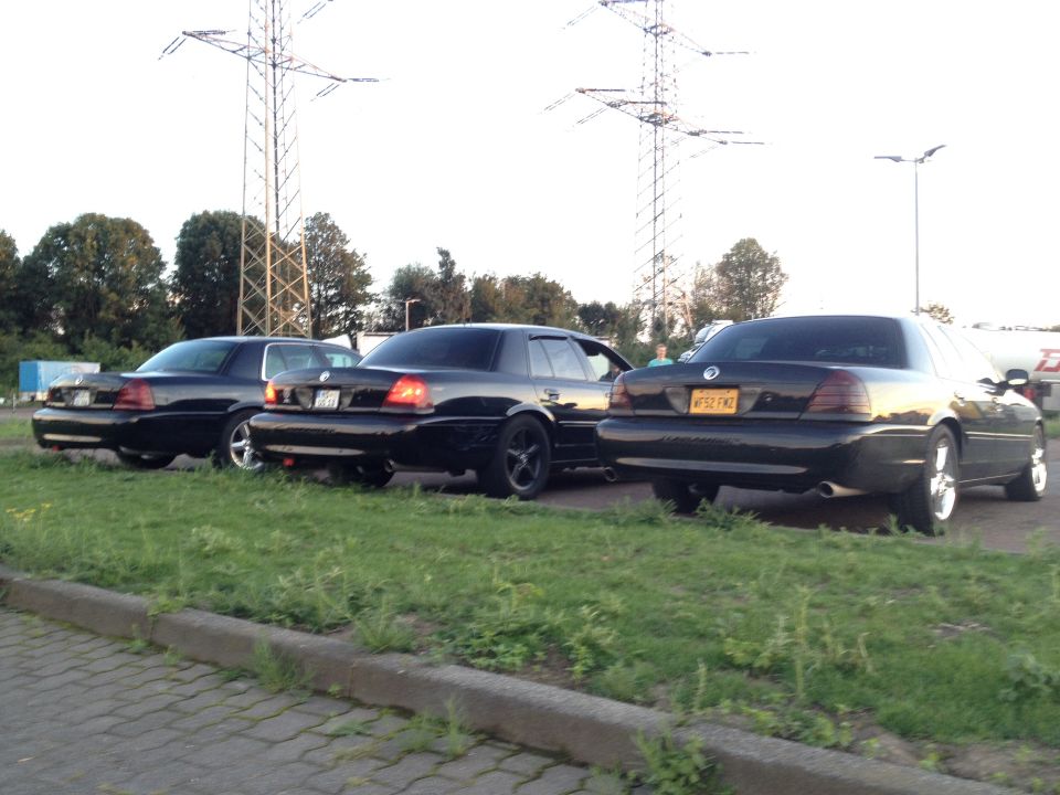 Rear view of three black 2003 Mercury Marauders parked side-by-side