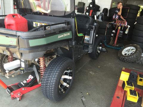 1988 Ford Bronco - A John Deere Gator UTV is shown from the rear, with a red gas can in the cargo bed and a jack under the rear axle.