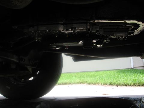 1994 Ford Bronco - Transmission pan removed for fluid change, showing internal components and dripping fluid.