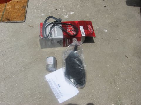1994 Ford Bronco - A transmission filter kit, including a gasket and fluid filter, is laid out on a concrete surface.