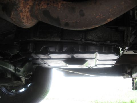 1994 Ford Bronco - Underside view shows the transmission pan and part of the exhaust system.