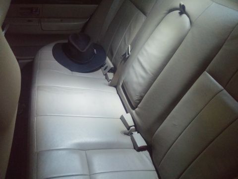 2000 Mercury Grand Marquis - Interior view of a car's back seat with a hat placed on it.