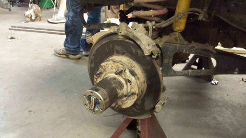 1996 Ford Bronco - Close-up of a front wheel hub assembly, likely from a 1996 Ford Bronco, showing the brake rotor and locking mechanism.