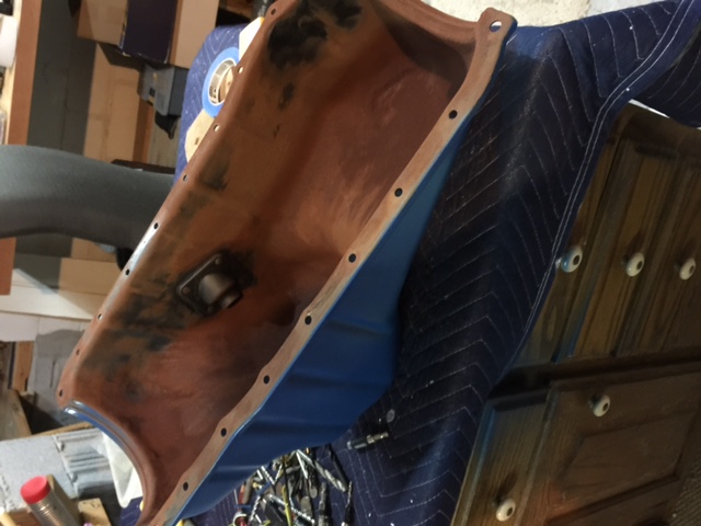 Oil pan with blue interior and brown exterior, showing mounting holes