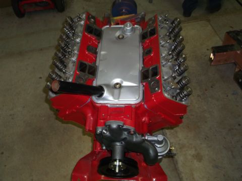 1957 Ford Custom Sedan - A V8 engine is shown with its red block and silver intake manifold. The valve springs are exposed.