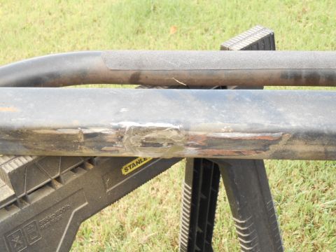 1994 Ford Bronco - Damaged vehicle sliders are shown resting on sawhorses outdoors.