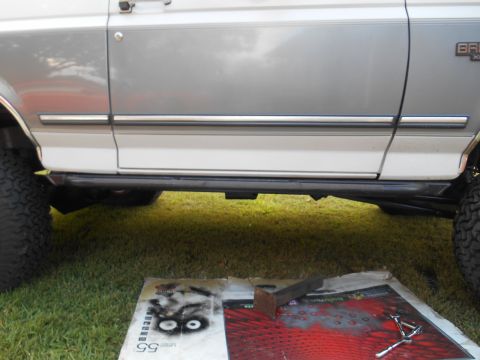 1994 Ford Bronco - Side profile of a 1994 Ford Bronco, highlighting its two-tone paint and installed sliders.