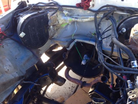 1978 Ford Bronco - The engine bay shows disassembled parts and wiring, suggesting recent work or an engine swap.
