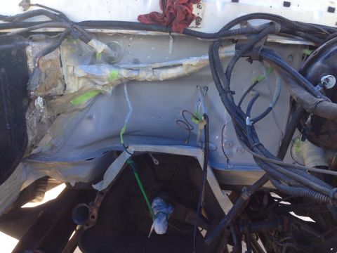 1978 Ford Bronco - Engine bay components covered for repair work, showing wiring and structural elements.