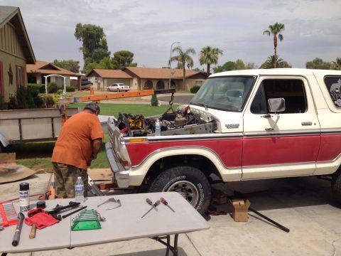 1978 Ford Bronco - Engine removal in progress on a 1978 Ford Bronco in a residential driveway.