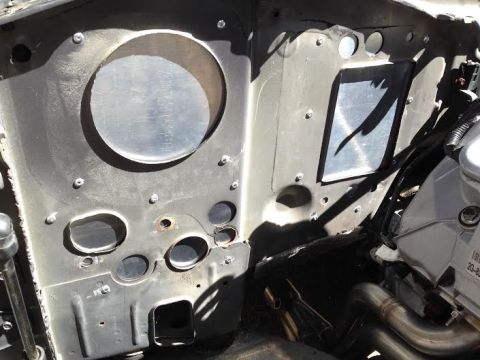 2004 Ford Crown Victoria - Close-up of a vehicle's engine bay firewall, showing modifications and engine parts.