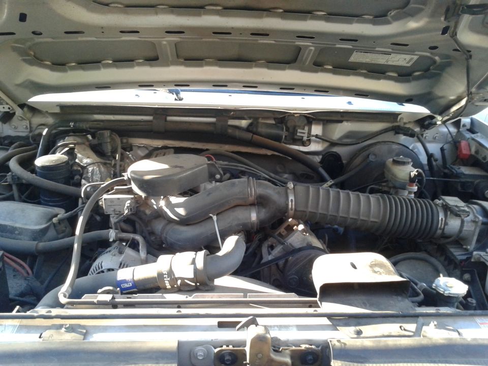 Engine compartment with hoses and air intake