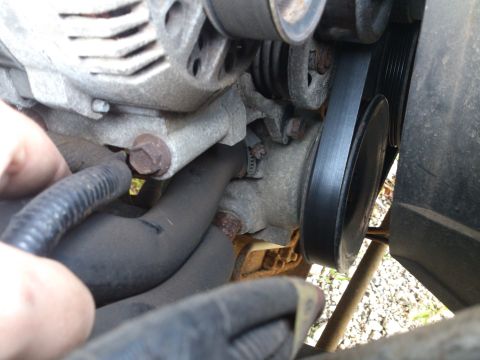 1995 Ford Bronco - Engine belt and alternator detail shot, no specific vehicle identified.