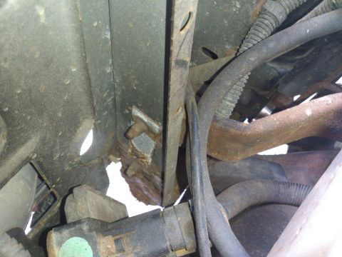1995 Ford Bronco - Undercarriage view shows significant rust on the frame and various hoses and wiring.