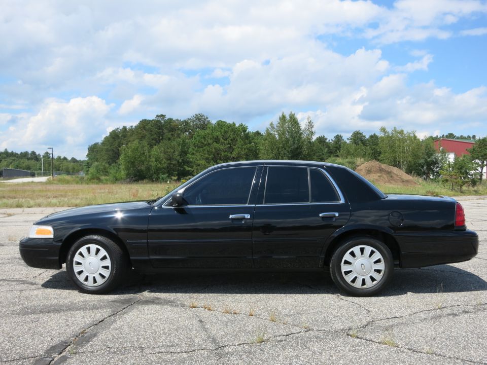 Side view of a black 2001 Ford Crown Victoria parked on asphalt