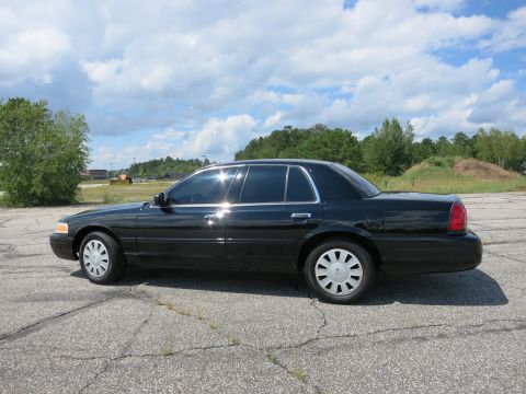 2001 Ford Crown Victoria - Side view of a black 2001 Ford Crown Victoria sedan parked outdoors.