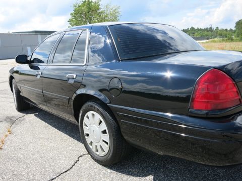 2001 Ford Crown Victoria - Rear three-quarter view of a black 2001 Ford Crown Victoria, tinted windows and rear window louvers.