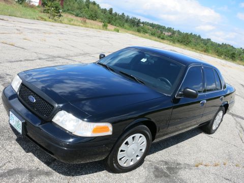 2001 Ford Crown Victoria - This black 2001 Ford Crown Victoria is shown from a 3q-front angle on a paved lot.