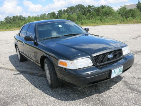 2001 Ford Crown Victoria - Front 3/4 view of a black 2001 Ford Crown Victoria sedan.