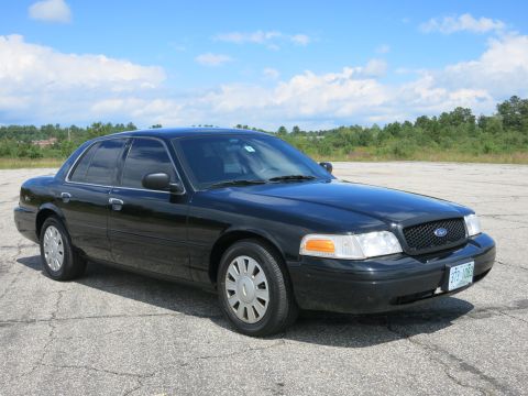 2001 Ford Crown Victoria - This black 2001 Ford Crown Victoria is shown from a 3q-front angle, displaying its license plate.