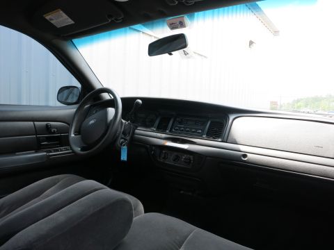 2001 Ford Crown Victoria - The interior of a car shows the dashboard, steering wheel, and front seats.