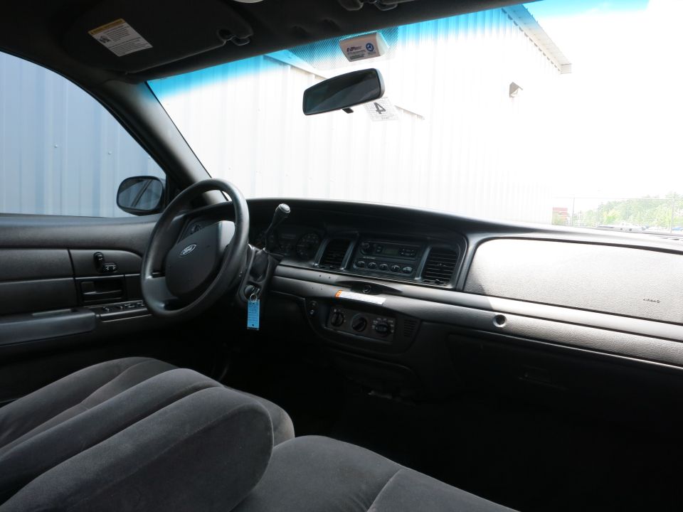 Interior view of a car's dashboard, steering wheel, and front seats