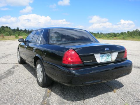 2001 Ford Crown Victoria - Rear view of a black 2001 Ford Crown Victoria sedan with a license plate from Massachusetts.
