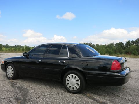 2001 Ford Crown Victoria - Side view of a black 2001 Ford Crown Victoria sedan parked outdoors.