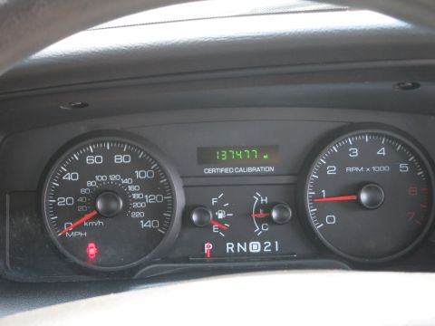 2001 Ford Crown Victoria - The vehicle's dashboard displays its current mileage, fuel level, and engine speed.