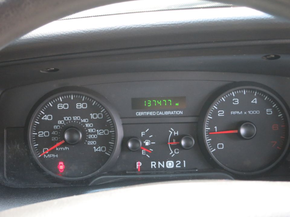 Speedometer, tachometer, fuel gauge, and odometer showing 137,477 miles