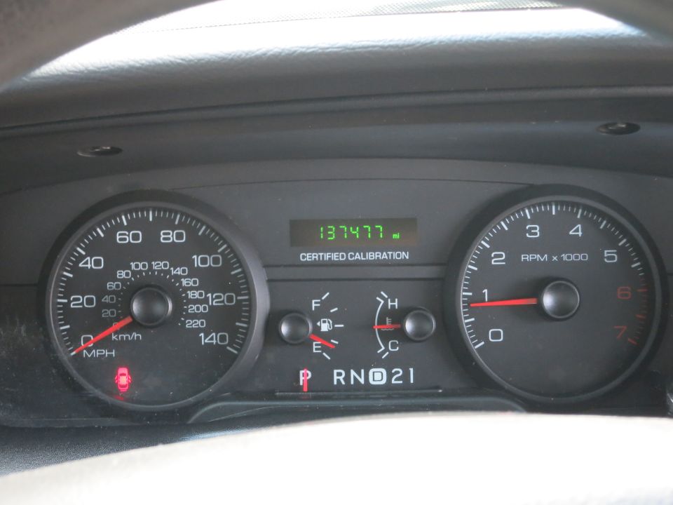 Dashboard gauges with odometer reading 137477 miles and tachometer