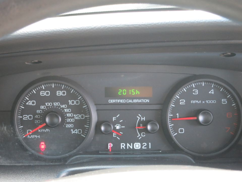 Dashboard gauges showing 2015 mileage and certified calibration