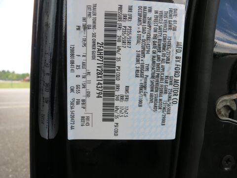 2001 Ford Crown Victoria - Ford Motor Co. door certification/data plate showing VIN, build date 01/08, GVWR, tire sizes and pressures, and color codes.