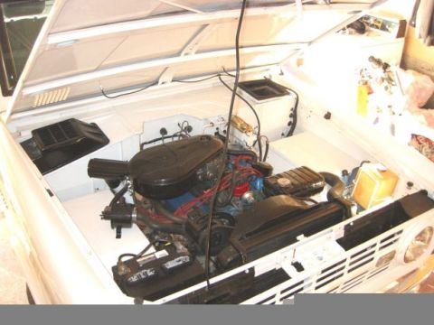1967 Ford Bronco - The engine bay of a 1967 Ford Bronco is visible with the hood raised.